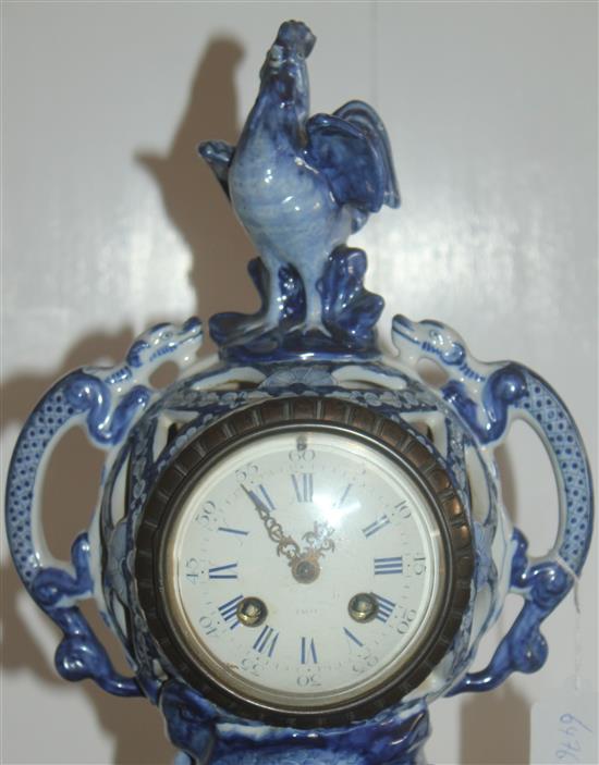 A 19th century French faience clock garniture, clock 18in.